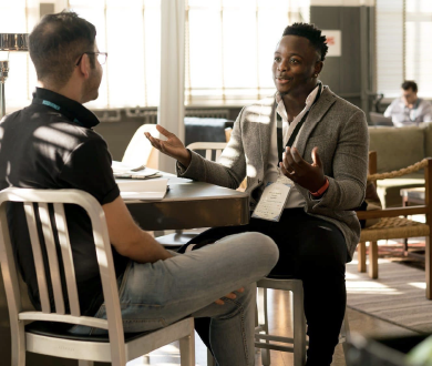 Two men seated having a conversation 